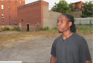 Omar Hardy, son of Clarence Hardy, at the back entrance to the Slave Theater.