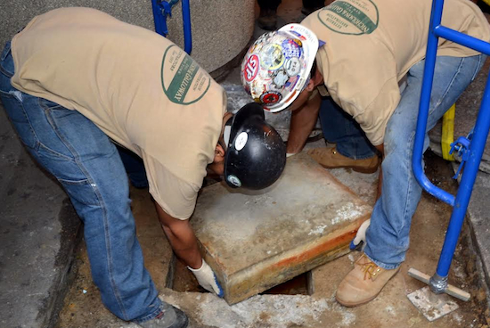 MTA employees dig up a time capsule that was buried beneath 370 Jay Street in 1950.