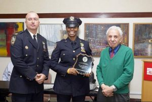 Captain Sergio Centa (left) and the 84th Precinct Community Council President Leslie Lewis (right) honored Det. Sheryl Wilson as its Cop of the Month at its monthly meeting on Tuesday night. Photo courtesy of Leslie Lewis.