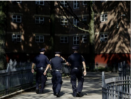 NYPD officers walking through a Brownsville housing project in August 2013.