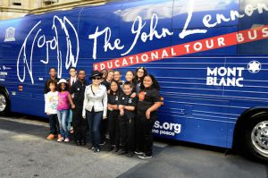 Yoko Ono Lennon, who supports the educational tour bus named after her late husband, rock legend John Lennon, is pictured with students at a recent tour bus stop.