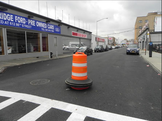 The Department of Transportation changed the direction of traffic on 89th Street between Fourth and Fifth avenues on Wednesday. A cone was placed in the street as a temporary stop-gap measure until permanent signage could be erected. A police car also blocked the street to prevent drivers from going the wrong way. Eagle photo by Paula Katinas