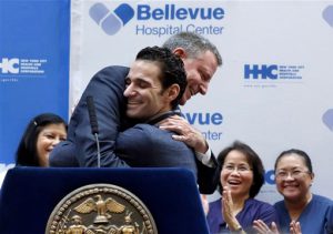 Dr. Craig Spencer, foreground, who was the first Ebola patient in New York City, is hugged by Bill de Blasio during a news conference at Bellevue Hospital on Tuesday. Spencer was released from Bellevue Hospital on Tuesday, 19 days after he was diagnosed with the virus. The physician had been working with Doctors Without Borders. AP Photo/Richard Drew