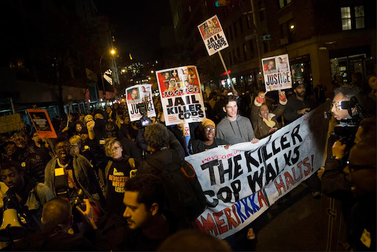 Protestors march toward Times Square after the announcement of the grand jury decision not to indict police officer Darren Wilson in the fatal shooting of Michael Brown, an unarmed 18-year-old black man on Monday in New York. AP Photo/John Minchillo