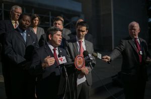 Councilmember Vincent Gentile (at podium) and several of his colleagues held a press conference at City Hall to call for federal approval of a policy to allow disabled veterans to use HOV lanes on highways at all times. City Council photo by William Alatriste