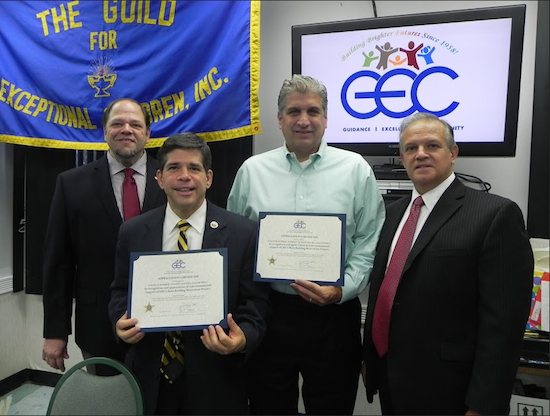 Paul Cassone (left), executive director of the Guild for Exceptional Children, is hoping that a new program by Investors Bank will help the organization’s fundraising effort. Cassone is pictured with Councilmember Vincent Gentile, former councilmember Domenic Recchia and Anthony Cetta, first vice president of the Guild’s Board of Directors (left to right), at an awards ceremony last year. Eagle file photo by Paula Katinas