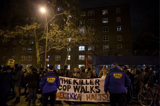 Demonstrators march in protest of the shooting death of Akai Gurley by rookie NYPD officer Peter Liang at the Louis Pink Houses public housing complex on Saturday in the Brooklyn borough of New York. Police have described Gurley's death as an apparent accident. AP Photo/John Minchillo