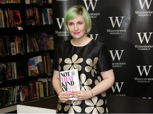 In this Oct. 29 photo, Brooklyn-born actress Lena Dunham holds her memoir, Not That Kind Of Girl, ahead of a book signing at Waterstones book shop, Piccadilly in central London. Photo by Joel Ryan/Invision/AP, File