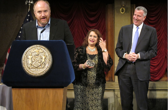 Louis C.K. addresses the audience while Media & Entertainment Commissioner Cynthia Lopez and Mayor Bill de Blasio look on. Photos by Matthew Taub