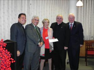 The Rev. Msgr. Robert Romano, (second from right) pastor of Our Lady of Guadalupe Church in Bensonhust, accepts his check from Pamela Brier, president and CEO of Maimonides Medical Center. Also pictured are the Rev. Msgr. Jamie Gigantiello; Dominick Stanzione, executive vice president and COO of the hospital; and state Sen. Marty Golden (left to right). Eagle photo by Paula Katinas