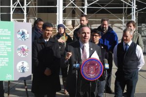 Councilmember Mark Treyger (at podium) says his legislation to prohibit the use of handheld phones while riding a bicycle is not aimed at raising revenue for the city. Photo courtesy Treyger’s office