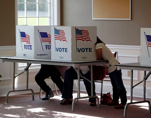 The ability to register at the poll on Election Day boosted new-voter turnout. AP Photo/Mike Groll