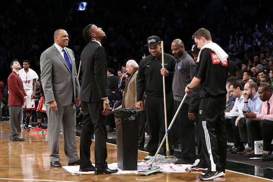 Lionel Hollins (left) and the Nets were all wet Tuesday night at Barclays Center thanks to a leak in the roof and a loss to the Miami Heat. AP photo