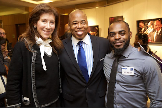 From left: Brooklyn Public Library President & CEO Linda Johnson and Brooklyn Borough President Eric Adams join Brooklyn-based entrepreneur Vander Carter as he celebrates winning the Brooklyn Public Library's PowerUP! Business Plan competition. Photo by Gregg Richards, courtesy of BPL