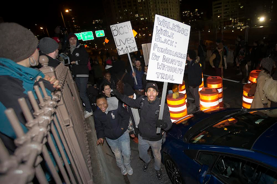 Demonstrators march over the inbound lane of the Brooklyn Bridge in New York on Saturday during the Justice for All rally and march. AP Photo/John Minchillo