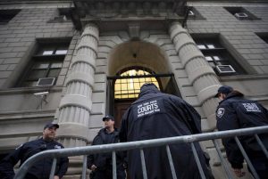 Security personnel stand outside Richmond County Supreme Court after a grand jury's decision not to indict a New York police officer involved in the death of Eric Garner on Dec. 3 in Staten Island. Staten Island Supreme Court Justice Stephen J. Rooney announced last week that he will remove himself from all Garner-related proceedings. AP Photo/John Minchillo