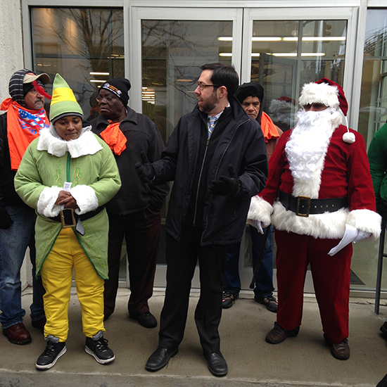 State Sen. Daniel Squadron (center) joins Build Up NYC activists, led by Santa Claus, at the Brooklyn Bridge Park Corporation (BBPC) Headquarters on Wednesday to push for transparency from the BBPC on the plans for housing at Pier 6.   Photo courtesy of Build Up NYC