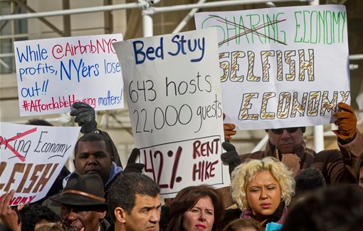 Opponents of Airbnb hold a rally outside City Hall on Tuesday in New York. With home-as-hotel sites like Airbnb doing booming business, New York City lawmakers are holding a hearing to scrutinizing how the trend affects the housing market and economy. AP Photo/Bebeto Matthews