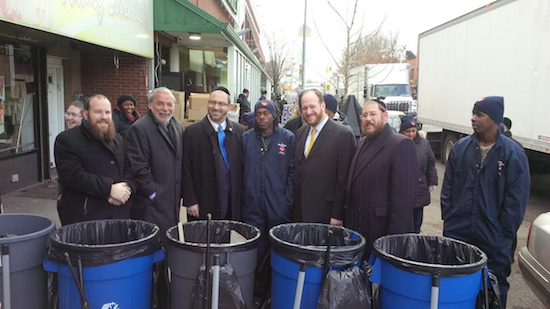 Local elected officials and Community Board 12 leaders join Project Sweep workers at the launch of the anti-litter program on 18th Avenue. Photo courtesy Felder’s office