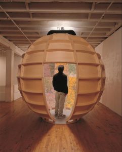 Artist Joyce Kozloff’s nine-foot diameter walk-in globe, painted with aerial maps of sites involved in U.S. military warfare, is part of the upcoming “Mapping Brooklyn” exhibition. Photo courtesy of BRIC