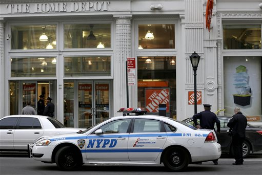 New York City Police officers stand in front of a Home Depot in Manhattan on Sunday. Police said an employee at the store argued with a co-worker before fatally shooting him and then killing himself. AP Photo/Seth Wenig