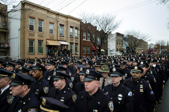 Thousands of police officers turned out to pay tribute to Det. Wenjian Liu at his funeral. AP Photo/John Minchillo