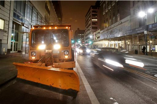 A New York City snowplow, loaded with salt, sits parked in midtown Manhattan as light snow falls on Monday. Northeast residents are girding for a heavy snowstorm that could bury communities from northern New Jersey to southern Maine in up to 2 feet of snow. AP Photo/Mark Lennihan