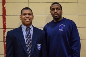 Sophomore Ramell Redd, pictured with football coach Kyron Jones, didn't always like Eagle Academy, but now credits his success in the classroom and on the football field to the Bed-Stuy school. He ran for more than 2,000 yards and scored nearly 30 touchdowns when he led the Eagles to a PSAL championship during their first year with a varsity program this year. Eagle photo by Rob Abruzzese