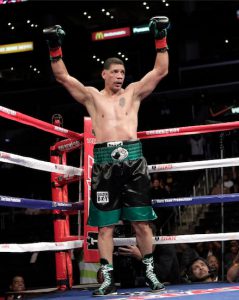 Dewey Bozella raises his arms in the fourth round of a boxing match with Larry Hopkins in Los Angeles on Oct. 15, 2011. Bozella won by unanimous decision after the fourth round. AP Photo/Jae Hong
