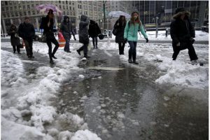 Pedestrians make their way around a deep slush puddle in New York City on Feb. 2. AP Photo/Seth Wenig