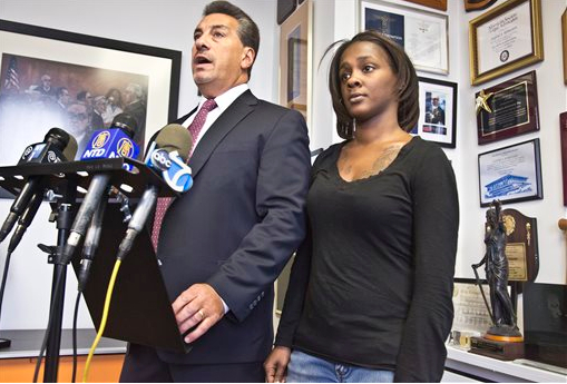 Attorney Scott Rynecki, left, and Kimberly Ballinger, the domestic partner of Akai Gurley and mother of his toddler daughter, hold a press conference on Jan. 29. Ballinger filed a lawsuit seeking $50 million against the city, the New York Police Department and officers Peter Liang and Shaun Landau in the shooting death of Akai in a Brooklyn housing project stairway. AP Photo/Bebeto Matthews