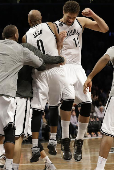 Jarrett Jack and Brook Lopez celebrate the Nets’ first home win since December on Monday night at Downtown’s Barclays Center. Associated Press photo