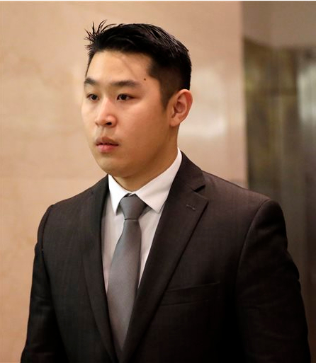 New York City rookie police officer Peter Liang, center, leaves the courtroom after he pleaded not guilty at his arraignment at Brooklyn Superior court on Wednesday. Liang, who fired into a darkened stairwell last November at a Brooklyn public housing complex, accidentally killing 28-year-old Akai Gurley, has been charged with manslaughter, official misconduct and other charges. He was released without bail. AP Photo/Mary Altaffer
