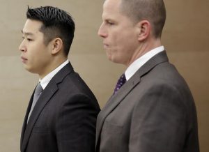 New York City rookie police officer Peter Liang, left, arrives at the courthouse for his arraignment on Feb. 11. AP Photo/Seth Wenig