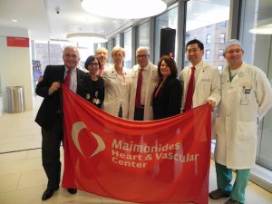 Members of the team responsible for the Heart & Vascular Center at Maimonides Medical Center present the flag in honor of National Heart Month. At left is Dominick Stanzione, executive vice president and COO of Maimonides. Eagle photo by Paula Katinas