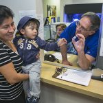 Pediatrician Charles Goodman talks with mom Carmen Lopez, 37, holding her 18-month-old son, Daniel after being vaccinated with the measles-mumps-rubella vaccine at his office in California, where the current outbreak began. AP Photo by Damian Dovarganes