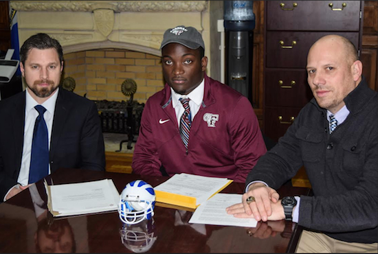 Lawrence Menyah (center) signed his National Letter of Intent on Wednesday with Brooklyn Tech Athletic Director Christopher LaCarrubba (left) and head coach Kyle McKenna (right) looking on. Eagle photo by Rob Abruzzese