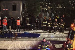 Emergency personnel work at the scene of a Metro-North Railroad passenger train and a vehicle accident in Valhalla, N.Y., Tuesday. Metro-North Railroad spokesman Aaron Donovan says the train struck a vehicle at a railroad crossing about 20 miles north of New York City. AP Photo/Robert Mecea