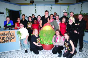 Members of the cast and crew of Adelphi Academy of Brooklyn’s production of “Little Shop of Horrors” strike a pose with Audrey II before the show.