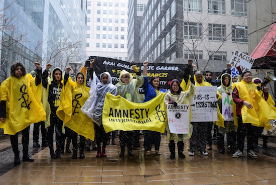 It was heavily snowing in Brooklyn Friday afternoon, but that didn’t stop hundreds of members from Amnesty International USA from putting on their ponchos and marching to the Brooklyn Bridge in honor of Akai Gurley, Eric Garner and Shereese Francis. Eagle photos by Rob Abruzzese