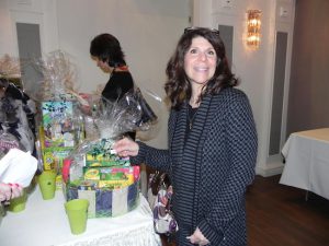 Sandy Irrera places her ticket in the cup for a chance to win one of the gift baskets at the luncheon. The organizers raffled off dozens of prizes to raise money for student scholarships. Eagle photo by Paula Katinas
