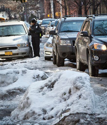 Cars are ticketed for violating alternate side parking along Sterling Street on Feb. 25 in Brooklyn. For the first time in weeks, New York City’s alternate side parking rules are back in place after being suspended to allow for snow removal as huge piles of ice and snow still remain on some city streets. AP Photo/Bebeto Matthews