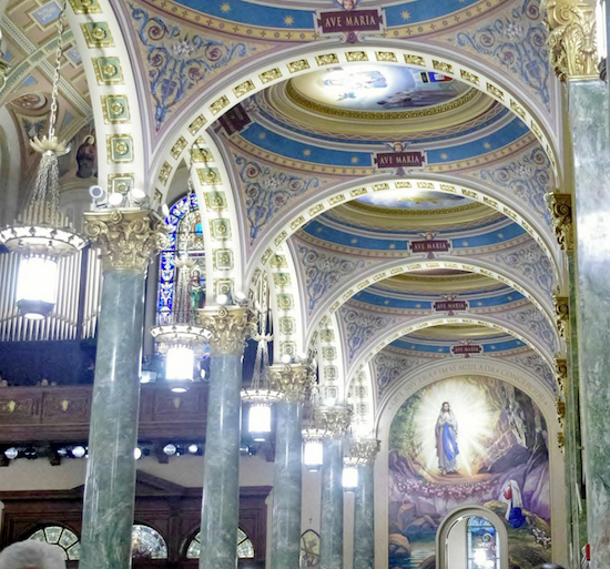 The side aisle ceilings at the Co-Cathedral of St. Joseph depict devotionals of the Blessed Mother from the language apostolates of many nationalities. This photo was taken at the May 13, 2014 re-dedication of St. Joseph’s Church as a co-cathedral. Photo by Francesca Norsen Tate