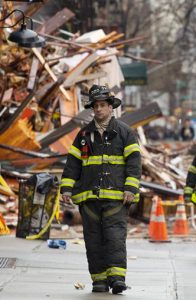 A firefighter walks away from a debris pile from collapsed buildings in the East Village on Friday. Authorities say two people are unaccounted for following an apparent gas explosion that leveled three buildings. Preliminary evidence suggested a gas explosion amid plumbing and gas work inside the building was to blame. AP Photo/Mark Lennihan