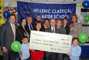 Educators from the Hellenic Classical Charter School accept the $150,000 grant from the Investors Foundation. Photo courtesy Investors Foundation