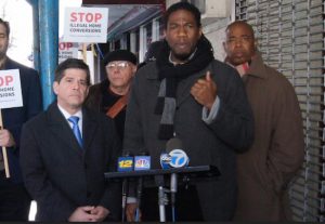 Councilmember Jumaane D. Williams stood with his council colleague Vincent Gentile (left), Brooklyn Borough President Eric Adams (right) and housing advocates in front of an apartment house and church to announce new legislation to combat illegal home conversions. Photo by Ernest Skinner/ NYC Council