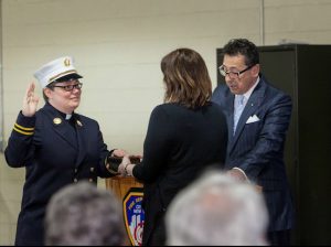 FDNY Commissioner Daniel Nigro swears in Rev. Ann Kansfield as the first female chaplain in the history of the FDNY. The Bible is being held by Rev. Kansfield’s wife, the Rev. Jennifer Aull. Photo by Tom Martinez