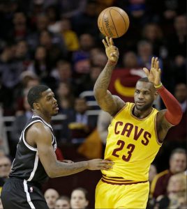 LeBron James passes over Joe Johnson Wednesday night as the Cleveland Cavaliers roll to a 117-92 victory over the Brooklyn Nets at Quicken Loans Arena. AP photo
