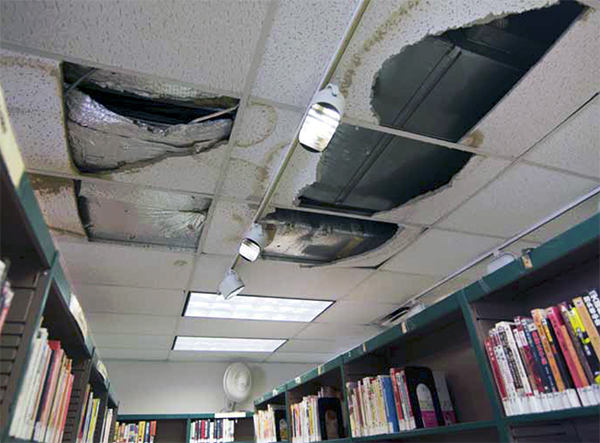 The Ulmer Park branch, on the edge of Bensonhurst, serving many new Chinese immigrants, suffers from chronic leaks and water damage, particularly on the ceiling over the Chinese language section. Photo courtesy of the Invest in Libraries Campaign