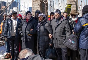 Brooklyn Borough President Eric Adams, left, linked arms with civil rights attorney Norman Siegel; Dr. Karen Daughtry, Pastor of House of the Lord Church; and state Sen. Jesse Hamilton. Eagle photo by Francesca Norsen Tate